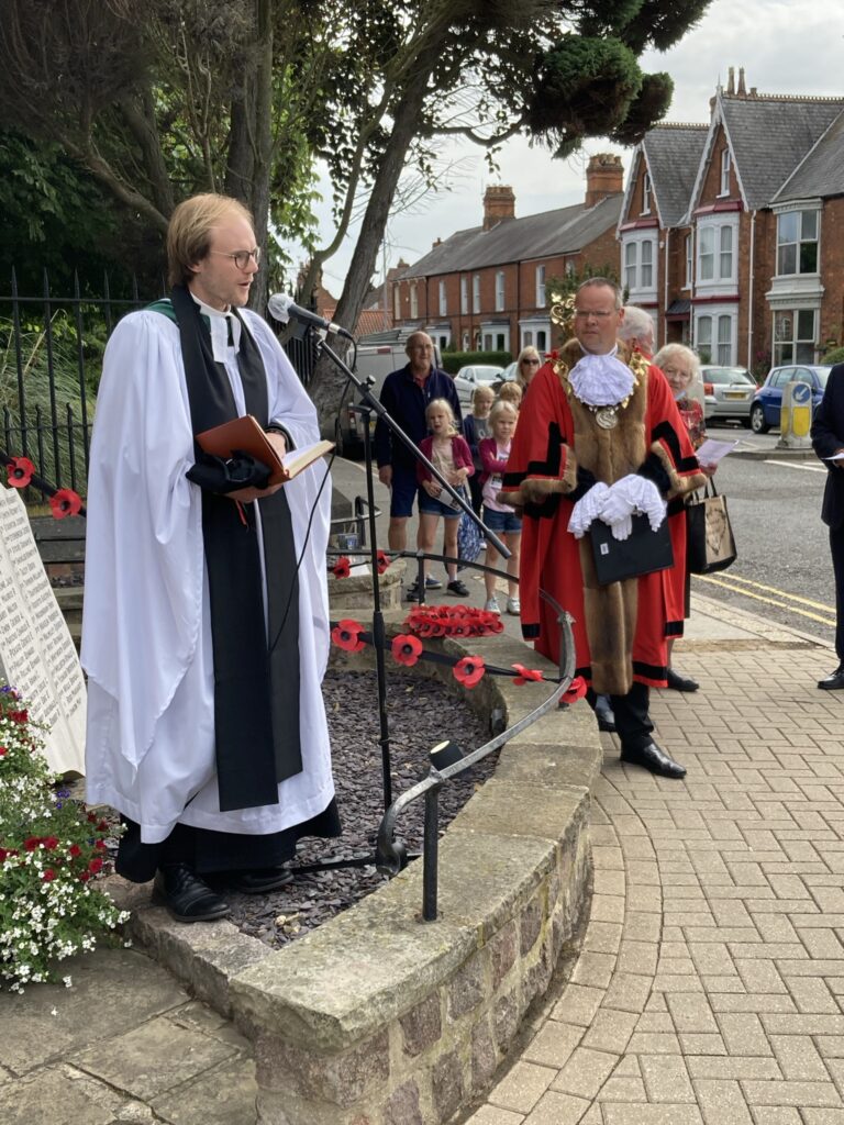 Rev'd James Robinson conducts service